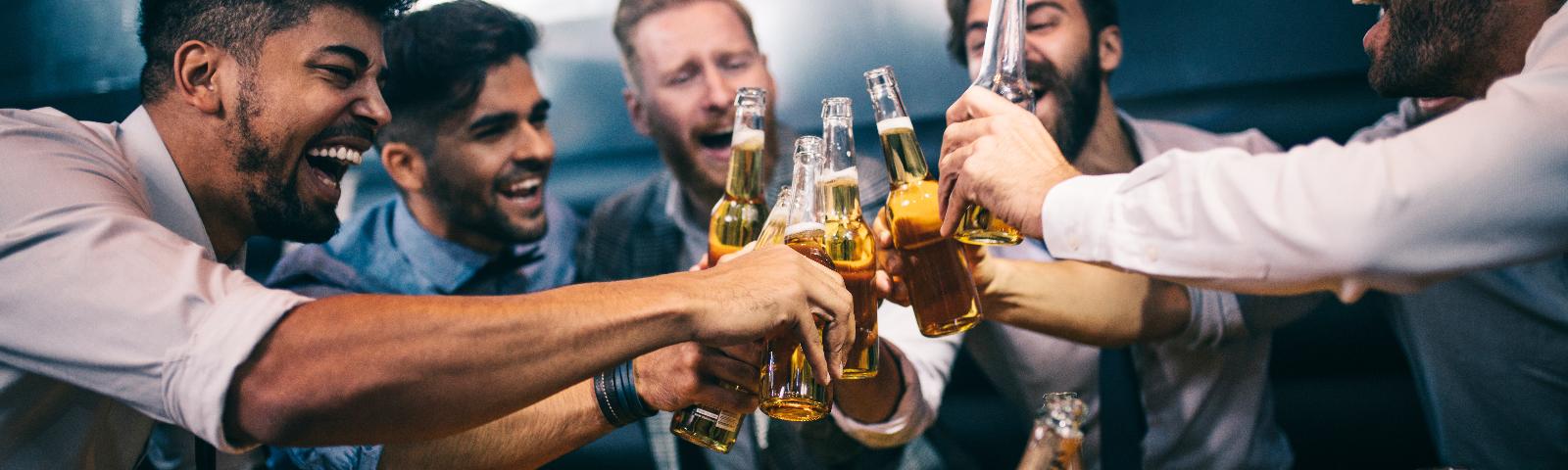 Group of males cheers their beers